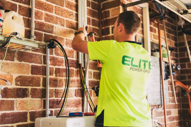 Electrician completing commercial wiring work in a Winchester workspace